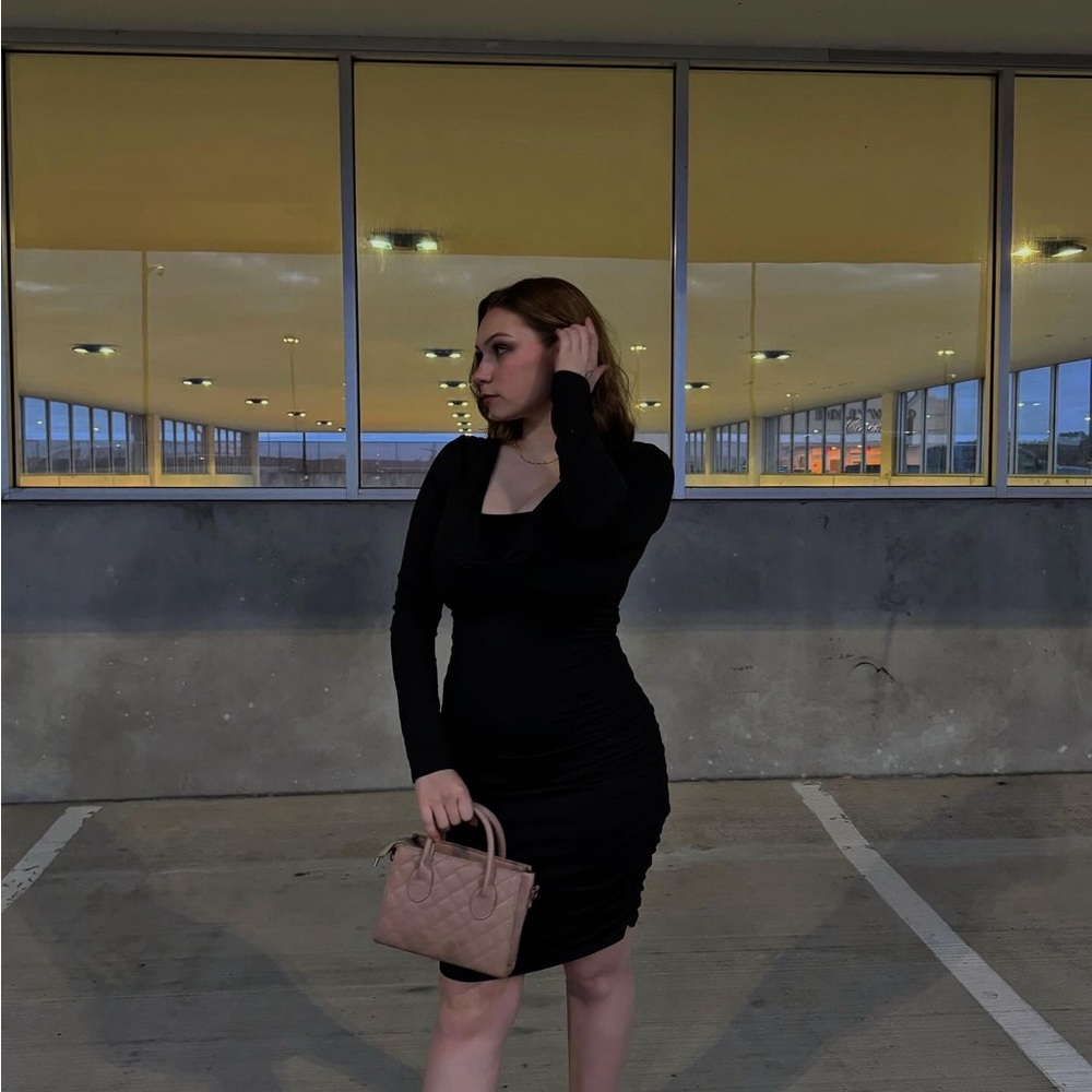 Long, black, body-hugging dress.